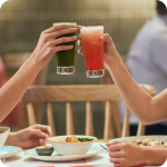 Toasting with glasses of juice